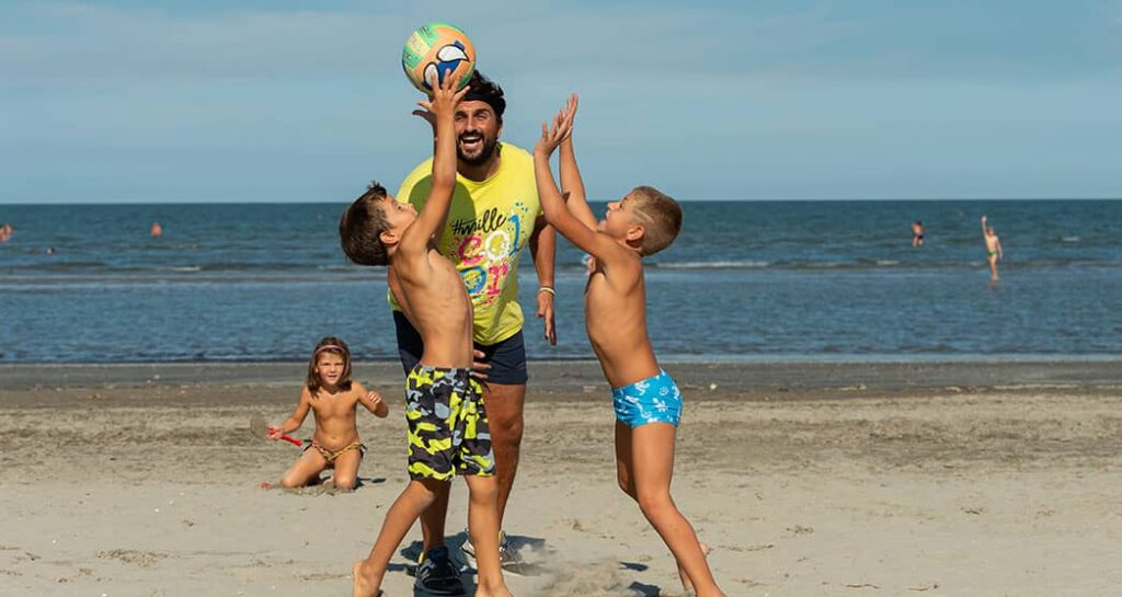 Animateure, die Kinder auf der Insel Albarella in Gruppenspiele einbeziehen